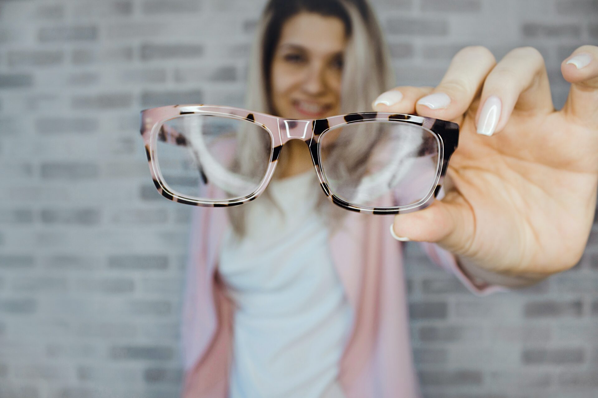Woman holding glasses Woman holding glasses