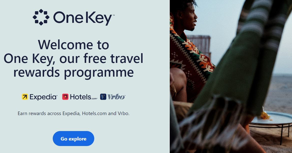 hotels.com loyalty programme An ad for One Key's travel rewards program featuring images of Expedia, Hotels.com, Vrbo logos, and a person holding a striped blanket near a scenic outdoor setting.